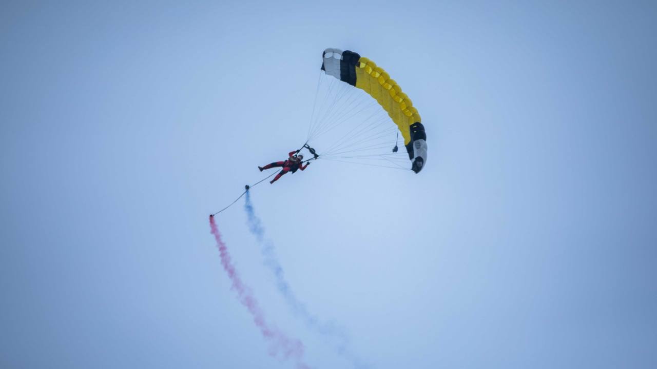 WHA Official Parachute Demonstration Team member performing a smoke display at the 2025 Wuhu Marathon