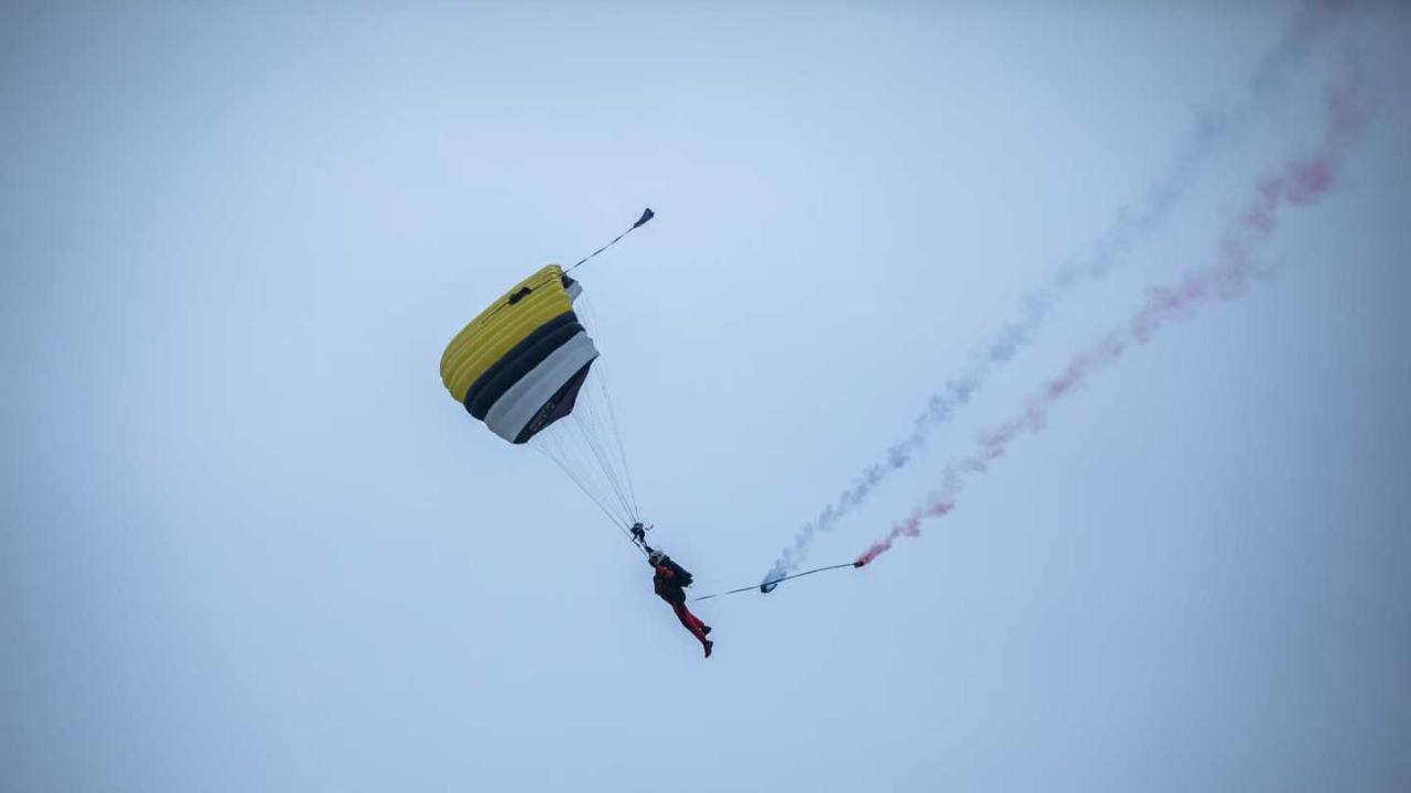 WHA parachute demonstration jumper performing a two-colour smoke display