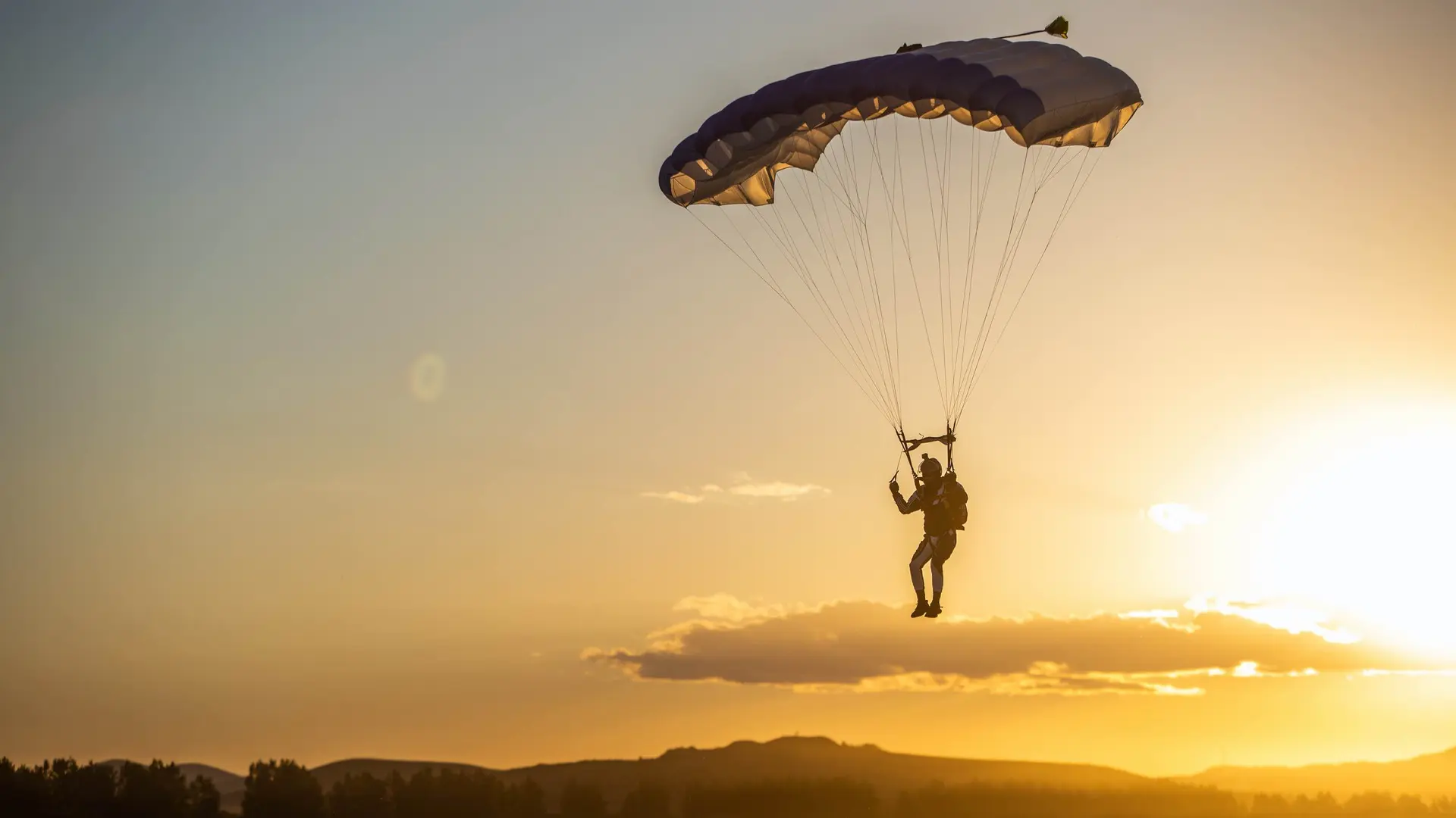 Skydiver flying a WHA Sport main canopy at sunset